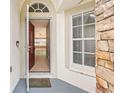 An open front door reveals a tiled foyer and a glimpse into the spacious living areas of the home at 12746 Standbridge Dr, Riverview, FL 33579