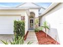 Inviting front entrance with stone accents, manicured landscaping, and a clear walkway to the front door at 12746 Standbridge Dr, Riverview, FL 33579