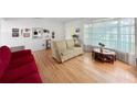 Bright living room featuring hardwood floors and abundant natural light at 14321 113Th Ave, Largo, FL 33774