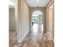 Inviting entryway featuring neutral walls, tile flooring, and an arched doorway at 16723 Blackwater Ter, Bradenton, FL 34202