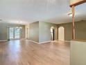Open living room area featuring beautiful wood floors and an abundance of natural light at 1914 Henley Rd, Lutz, FL 33558