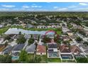 Aerial view of the neighborhood showcases the home's location near a pond and lush greenery at 1933 Fruitridge St, Brandon, FL 33510