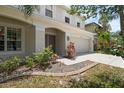 Charming home features a well-manicured lawn, neutral paint, and an attached two-car garage at 1933 Fruitridge St, Brandon, FL 33510