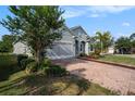Stylish single-Gathering home with a brick driveway and attached two-car garage at 212 Shell Creek Ct, Apollo Beach, FL 33572