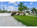 Spacious corner lot featuring a well-manicured lawn and a white vinyl fence at 2204 78Th W St, Bradenton, FL 34209