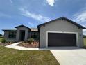 The house boasts a well-manicured lawn and an attached two-car garage at 2330 Hiers Rd, Dover, FL 33527