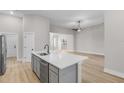 Spacious kitchen with island, stainless steel appliances, and hardwood flooring at 2402 Hiers Rd, Dover, FL 33527