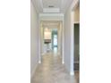 Inviting hallway with tile flooring, leading to the kitchen and other living areas at 24815 Lambrusco Loop, Lutz, FL 33559