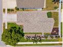 Aerial view of home featuring a backyard fire pit area, landscaping, and well-maintained roof at 2708 Dolphin Watch Ct, Holiday, FL 34691