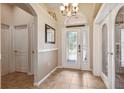 Inviting foyer with decorative glass front door, tiled flooring, and access to additional rooms at 2708 Dolphin Watch Ct, Holiday, FL 34691