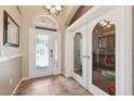 Bright and airy foyer with decorative glass doors and tiled flooring, offering a welcoming entrance at 2708 Dolphin Watch Ct, Holiday, FL 34691