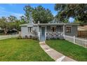 A charming home with a picket fence and colorful front flower garden at 300 33Rd N Ave, St Petersburg, FL 33704