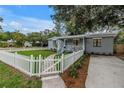 Charming home with a white picket fence and a well-manicured front yard at 300 33Rd N Ave, St Petersburg, FL 33704