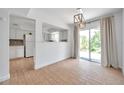 Bright dining area featuring sliding glass doors and wood-look floors at 3865 Gatewood Dr, Sarasota, FL 34232