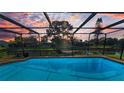 Enclosed pool with clear blue water, offering a private and serene outdoor space at 395 Forest Park Rd, Oldsmar, FL 34677