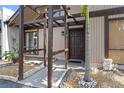 Inviting entryway featuring a modern pergola, elegant landscaping, and a freshly painted front door at 4013 Muriel Pl, Tampa, FL 33614