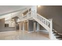 Open living space with staircase, modern lighting, and glossy tile flooring at 4013 Muriel Pl, Tampa, FL 33614