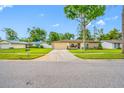 Inviting home with a two-car garage, a well-kept lawn, and established landscaping, offering great curb appeal at 4220 Woodlark Dr, Tampa, FL 33624