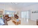 Bright living room with hardwood floors, comfortable seating, and sliding glass doors at 4368 Las Palmas Ave, Spring Hill, FL 34606