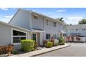 Well-manicured townhome with neutral siding, large windows, and mature landscaping at 500 New York Ave # 23, Dunedin, FL 34698