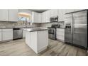 Modern kitchen with stainless steel appliances, granite countertops, and island at 5160 Loquat Ct, Palm Harbor, FL 34685