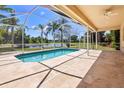 Inviting screened-in pool area with beautiful lake views at 5160 Loquat Ct, Palm Harbor, FL 34685