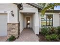 Inviting entryway with brick-paver walkway and stone accents, leading into a bright and modern home at 5634 Clearwater Ct, Lakewood Ranch, FL 34211