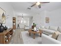 Bright living room with white walls, wood-style flooring, and stylish furnishings for a welcoming atmosphere at 6229 Bayside Key Dr, Tampa, FL 33615
