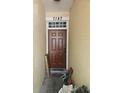 Inviting front door displaying the house number, complemented by a secure entrance and textured facade at 7187 53Rd N St, Pinellas Park, FL 33781