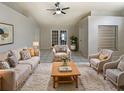 Bright living room with a cozy rug, neutral furniture, and sliding doors leading to the backyard at 8812 Bayaud Dr, Tampa, FL 33626
