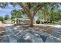 A quaint home with a detached garage and mature trees in a quiet neighborhood at 1117 Tyrone N Blvd, St Petersburg, FL 33710