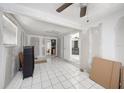 Large basement features white ceramic tile flooring and a partial view into the living room at 11486 92Nd N St, Largo, FL 33773
