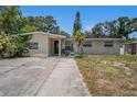 Inviting single-Gathering home with a well-lit entry, fresh paint, and a neatly maintained front lawn at 11486 92Nd N St, Largo, FL 33773
