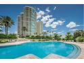 Beautiful pool area surrounded by lush greenery, creating a tranquil oasis near high-rise buildings at 1180 Gulf Blvd # 306, Clearwater, FL 33767