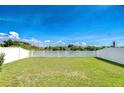 Spacious, well-maintained backyard with a white vinyl fence, offering privacy and room for outdoor activities at 1210 Harbour Blue St, Ruskin, FL 33570