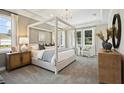 Tranquil main bedroom with a tray ceiling, canopy bed, neutral color palette and lots of natural light at 125 Hidden Estates Ct, Brandon, FL 33511
