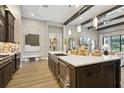 Open kitchen with a large center island, stainless steel appliances and hardwood flooring at 125 Hidden Estates Ct, Brandon, FL 33511