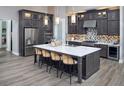 Modern kitchen features stainless steel appliances, center island with breakfast bar, and custom cabinetry at 125 Hidden Estates Ct, Brandon, FL 33511