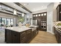 Spacious kitchen featuring a large island, modern stainless appliances, stylish cabinetry and hardwood floors at 125 Hidden Estates Ct, Brandon, FL 33511