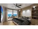 Beautiful bedroom with ocean view, ceiling fan, built-in shelving, and balcony access at 14048 Gulf Blvd # 302, Madeira Beach, FL 33708