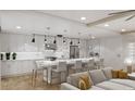 Bright open kitchen featuring a center island with white marble countertop and modern pendant lighting at 14048 Gulf Blvd # 302, Madeira Beach, FL 33708