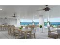 A furnished outdoor terrace overlooking the ocean, offering an amazing space for dining and relaxing with Gathering and friends at 14048 Gulf Blvd # 201, Madeira Beach, FL 33708