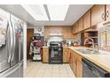 Functional kitchen features light wood cabinetry, appliances, and a skylight for natural light at 14339 Mayer Ave, Hudson, FL 34669