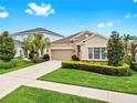 Inviting one-story home with manicured lawn, two-car garage, and charming landscaping at 17610 Buckingham Garden Dr, Lithia, FL 33547