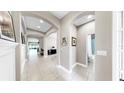 Hallway showcasing archways, tile flooring, and decorative wall accents at 17610 Buckingham Garden Dr, Lithia, FL 33547