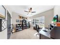 Bright home office with desk, chair, bookshelves, and a window with natural light at 17610 Buckingham Garden Dr, Lithia, FL 33547