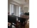Bright dining area with a wooden table, natural light, and a functional layout at 18063 Parrot Rd, Weeki Wachee, FL 34614
