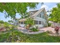 Charming home with light blue siding, unique white block foundation, and beautiful landscaping at 1825 2Nd S St, St Petersburg, FL 33705