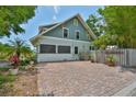 Side exterior showing a well maintained fence and a large brick area at 1825 2Nd S St, St Petersburg, FL 33705