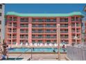 Exterior swimming pool at The Beach Cottage II complex with many lounge chairs at 18400 Gulf Blvd # 2505, Indian Shores, FL 33785
